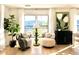Bright and airy living room with neutral colors, large windows, and stylish decor creating a comfortable space at 937 Nettuno Dr, Venice, FL 34285