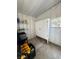 Organized shed space with a white cabinet, storage shelves, and a small window at 937 Nettuno Dr, Venice, FL 34285