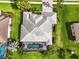 Aerial view of the house and pool, highlighting the roof and well-manicured landscaping at 988 145Th Street Ne Cir, Bradenton, FL 34212