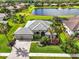 Aerial view of the property showcasing the home's exterior, landscaping, and surrounding area at 988 145Th Street Ne Cir, Bradenton, FL 34212