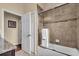 Bright bathroom featuring tub with shower and modern fixtures at 988 145Th Street Ne Cir, Bradenton, FL 34212