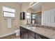 Well-lit bathroom with granite counters, vanity, toilet and shower at 988 145Th Street Ne Cir, Bradenton, FL 34212