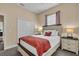 Well-lit bedroom features a king-size bed, carpet, a closet and two bedside tables at 988 145Th Street Ne Cir, Bradenton, FL 34212