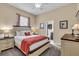 Bright bedroom with a king-size bed, neutral tones and ensuite bathroom access at 988 145Th Street Ne Cir, Bradenton, FL 34212
