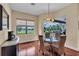 Cozy breakfast nook with water views and glass table with wicker chairs at 988 145Th Street Ne Cir, Bradenton, FL 34212