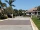 Gated community entrance with brick-paved road, providing security and exclusivity for residents at 988 145Th Street Ne Cir, Bradenton, FL 34212