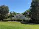 Welcoming entrance sign to 'The Enclave' community amidst lush landscaping and clear blue skies at 988 145Th Street Ne Cir, Bradenton, FL 34212