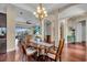 Elegant dining room with hardwood floors, chandelier, and an open view to the living room at 988 145Th Street Ne Cir, Bradenton, FL 34212
