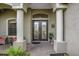 Close-up of the elegant double front doors, with sidelights, columns, and brick paved entrance at 988 145Th Street Ne Cir, Bradenton, FL 34212
