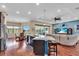 Open concept kitchen with island, bar seating, stainless steel appliances, and a breakfast nook with pool views at 988 145Th Street Ne Cir, Bradenton, FL 34212