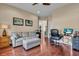 Comfortable living room with hardwood floors, a plush sofa, ottoman, desk and modern decor at 988 145Th Street Ne Cir, Bradenton, FL 34212
