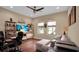 Comfortable home office setup with a large sofa, TV, shelving, and natural light at 988 145Th Street Ne Cir, Bradenton, FL 34212