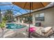 Inviting pool and patio area with lounge chairs and beautiful lush landscaping at 988 145Th Street Ne Cir, Bradenton, FL 34212