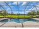 Inviting pool with brick patio inside of screened enclosure and lush landscaping at 988 145Th Street Ne Cir, Bradenton, FL 34212