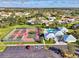 Aerial view showcasing the community's tennis courts, pool, clubhouse, and parking area at 3008 Sail Pointe Cir # 2C, Venice, FL 34293