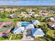 Aerial view of community amenities, showcasing tennis courts, pool, clubhouse, and manicured landscaping at 3008 Sail Pointe Cir # 2C, Venice, FL 34293