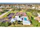 A picturesque aerial view showing the pool, tennis courts, parking, and surrounding neighborhood at 3008 Sail Pointe Cir # 2C, Venice, FL 34293