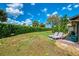 Spacious backyard with manicured lawn, privacy hedge, and sunbathing area at 3008 Sail Pointe Cir # 2C, Venice, FL 34293