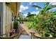 Lush backyard featuring tropical plants, seating, and manicured landscaping at 3008 Sail Pointe Cir # 2C, Venice, FL 34293
