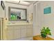 Well-lit bathroom featuring a neutral vanity with framed mirror and decorative accents at 3008 Sail Pointe Cir # 2C, Venice, FL 34293