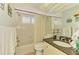 Traditional bathroom featuring a vanity with granite countertop and a tub with shower at 3008 Sail Pointe Cir # 2C, Venice, FL 34293