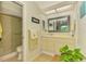 Bright bathroom featuring a vanity with storage, a framed mirror, and a separate shower area at 3008 Sail Pointe Cir # 2C, Venice, FL 34293
