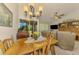 Inviting dining area with wood table, natural light, and access to the lanai at 3008 Sail Pointe Cir # 2C, Venice, FL 34293