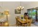 Cozy dining space with wood table and chairs, seamlessly connected to outdoor views at 3008 Sail Pointe Cir # 2C, Venice, FL 34293