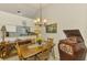 Charming dining room featuring wood table, adjacent living space, and vintage decor at 3008 Sail Pointe Cir # 2C, Venice, FL 34293