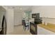 Functional kitchen with modern appliances, white cabinets, and easy access to an outdoor patio seating area at 3008 Sail Pointe Cir # 2C, Venice, FL 34293