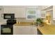 Well-lit kitchen with stainless steel sink, range, and ample cabinet space at 3008 Sail Pointe Cir # 2C, Venice, FL 34293