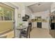 Efficient kitchen with modern appliances and access to an outdoor patio with a table and chairs at 3008 Sail Pointe Cir # 2C, Venice, FL 34293