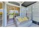 Enclosed lanai offering comfortable seating and a view of the landscaped backyard at 3008 Sail Pointe Cir # 2C, Venice, FL 34293