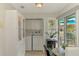 Well-equipped laundry area featuring a washer, dryer, storage cabinets, and easy access to the outdoor patio at 3008 Sail Pointe Cir # 2C, Venice, FL 34293