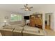 Bright living room featuring a ceiling fan, stylish shutters, comfortable seating, and neutral decor at 3008 Sail Pointe Cir # 2C, Venice, FL 34293