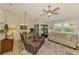 Inviting living room featuring a ceiling fan, comfortable seating, and a neutral color palette at 3008 Sail Pointe Cir # 2C, Venice, FL 34293