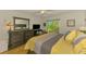 Bright main bedroom with hardwood floors, sliding glass door, and tasteful furnishings at 3008 Sail Pointe Cir # 2C, Venice, FL 34293