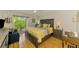Comfortable main bedroom with stylish furniture, hardwood floors, and outdoor access at 3008 Sail Pointe Cir # 2C, Venice, FL 34293
