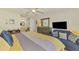 Sunlit main bedroom featuring a comfortable bed, dresser, and ensuite bathroom at 3008 Sail Pointe Cir # 2C, Venice, FL 34293