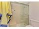 Updated bathroom featuring a glass-enclosed shower with a built-in seat and convenient grab bar at 3008 Sail Pointe Cir # 2C, Venice, FL 34293