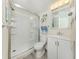 Modern bathroom with glass shower, white vanity and coastal-themed decor at 1001 Inlet Cir # 269, Venice, FL 34285