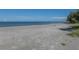 View of the beach, with calm, clear water and a sandy shoreline at 1001 Inlet Cir # 269, Venice, FL 34285