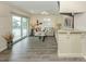 Bright living room with tile floors, coastal decor, sliding glass doors, and a granite countertop bar area at 1001 Inlet Cir # 269, Venice, FL 34285