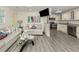 Inviting living room and kitchen with white cabinetry, stainless steel appliances, and beach decor at 1001 Inlet Cir # 269, Venice, FL 34285