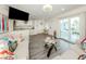 Living room with combined kitchen area featuring coastal decor, tile floors, stainless appliances, and sliding glass doors at 1001 Inlet Cir # 269, Venice, FL 34285