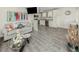 Living room and kitchen area with tile floors, coastal decor, stainless appliances and decorative wall art at 1001 Inlet Cir # 269, Venice, FL 34285