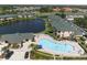 Aerial view of community pool, lake, and neighborhood, featuring lush landscaping and ample parking at 1007 Gondola Park Dr # 1007, Venice, FL 34292