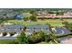 High-angle aerial showcasing neighborhood homes with a golf course, pond and scenic landscape at 1007 Gondola Park Dr # 1007, Venice, FL 34292