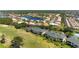 Aerial view of a community with lake, golf course and tennis courts near condominium homes at 1007 Gondola Park Dr # 1007, Venice, FL 34292