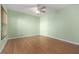 Bedroom featuring wood floors, a ceiling fan, and large windows at 1007 Gondola Park Dr # 1007, Venice, FL 34292